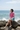 Asian model — denim shorts, beach rocks