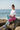 Asian model — tied white tee, beach rocks