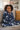 Black girl wrapped in blanket on couch