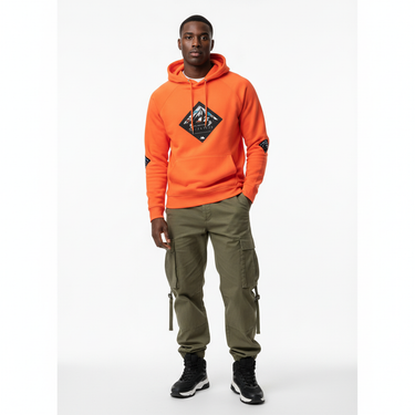 Black male model in burnt orange Slalom hoodie with cargo pants