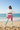 Black model — crop hoodie, sunglasses, beach waves