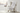 Blanket draped over white chair by window