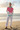 Blonde model — white linen pants, beach