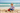 Boy at beach building sandcastle
