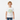 Boy in white tee standing