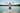 Boy jumping into lake