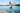 Boy jumping into lake