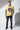 Cornsilk yellow tee with one hand in pocket