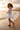 Curly-haired model — mini skirt, shoreline
