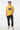 Daisy yellow tee with one hand in pocket