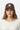 Female model close-up wearing brown trucker hat relaxed
