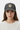 Female model close-up wearing charcoal trucker hat