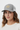 Female model close-up wearing heather grey trucker hat