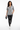 Female model in black leather pants and white sneakers