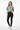 Female model in high-waisted jeans and white sneakers