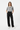 Female model in wide-leg pants and white sneakers