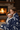 Girl with hot cocoa by fireplace