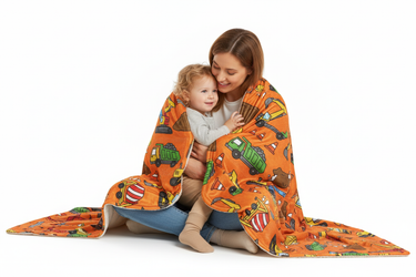 Parent and child cuddling with construction blanket white background