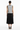 Back view of vest with pleated midi skirt