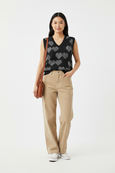Geometric hearts vest with beige corduroy pants for relaxed casual style