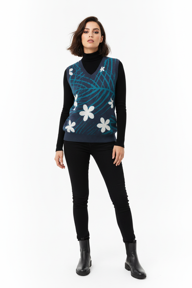 Tropical palm vest over black turtleneck for statement look