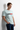 Light blue t-shirt leaning against wall