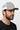 Male model close-up side profile wearing heather grey trucker hat