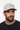 Male model close-up three-quarter view wearing silver trucker hat