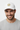 Male model close-up wearing white trucker hat