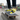 Man wearing yellow and black slip-ons on skateboard with denim