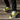 Man wearing yellow and black slip-ons with cargo pants on stairs