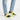 Man wearing yellow and black slip-ons with light denim, standing pose