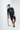 Navy blue tee with tattoos leaning