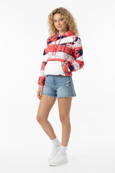 3/4 Front - White female model, SURFXION hoodie, jean shorts