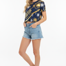 3/4 Front - White model, denim shorts