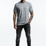 All-over print tee with tattooed model, one hand in pocket