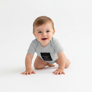 Baby boy in heather gray bodysuit crawling