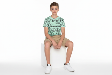Boy seated on cube