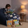 Child reading with blanket in cozy corner