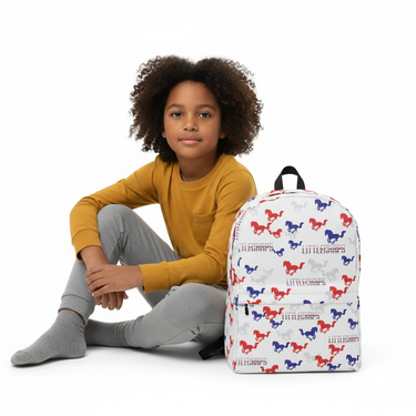 Child sitting with backpack beside them