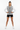 Female model in black athletic shorts and white sneakers