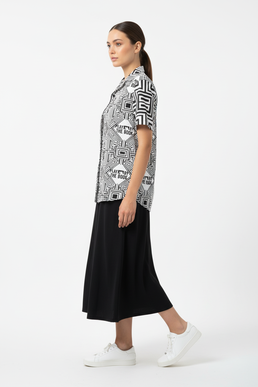 Female model in black midi skirt and white sneakers