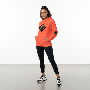 Female model in burnt orange Slalom hoodie with leggings
