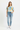 Female model in light wash jeans and white sneakers
