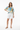 Female model in white shorts and tan sandals