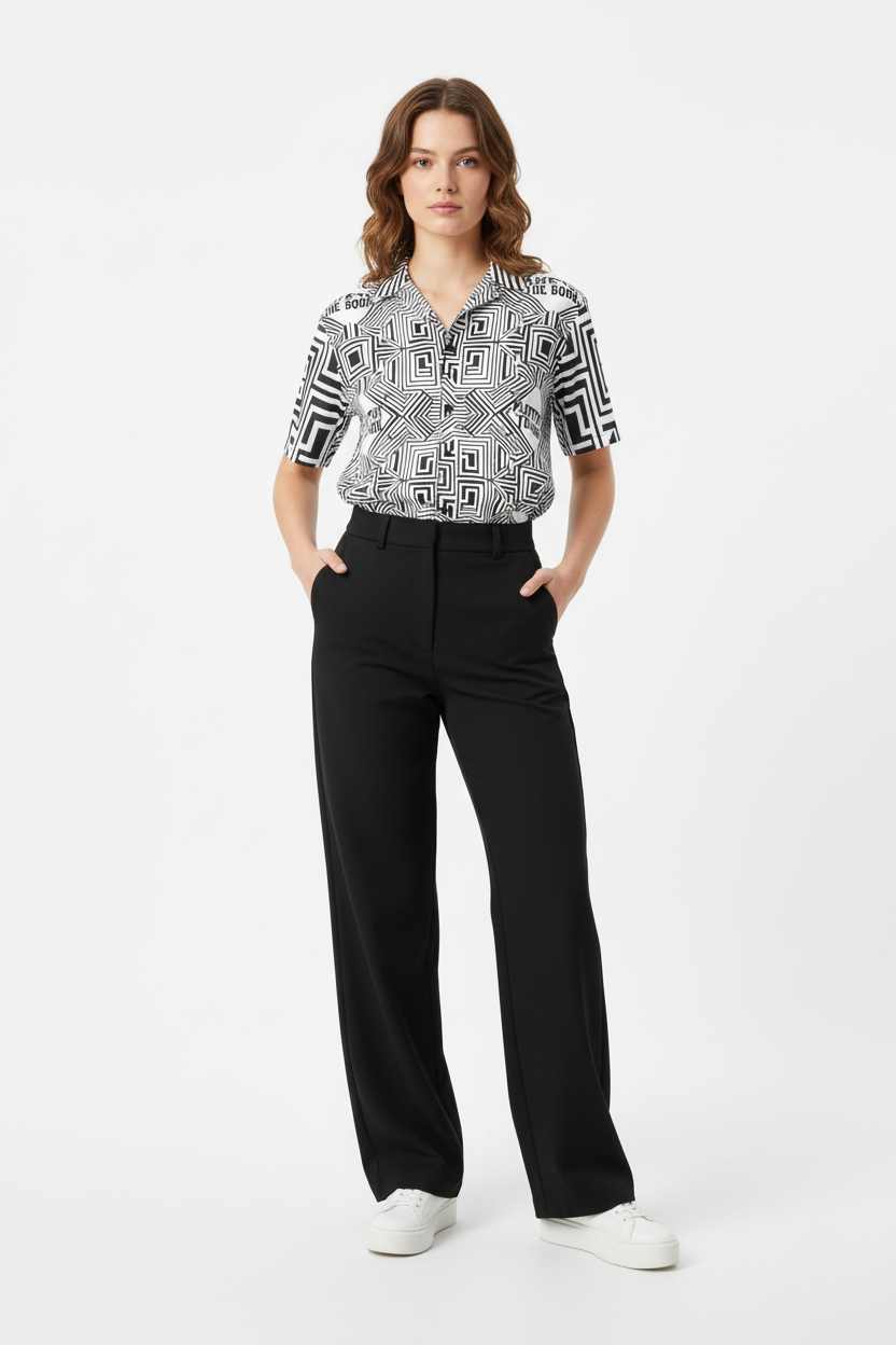 Female model in wide-leg pants and white sneakers