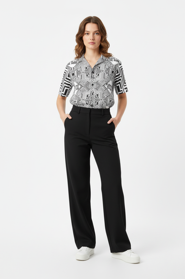 Female model in wide-leg pants and white sneakers