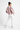 Female model three-quarter back with white pants