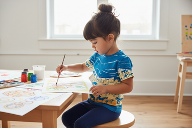 Girl painting at art table