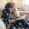 Girl reading with blanket